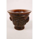 A Chinese faux horn libation cup with carved kylin decoration, impressed mark to base, 3" high