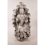 A large Chinese blanc de chine figure of Quan Yin seated within a lotus leaf, impressed marks verso,