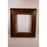 An antique fruitwood picture frame with carved ripple decoration, aperture size 12½" x 10½"