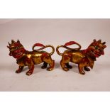 A pair of Tibetan painted and gilt brass kylin, 5½" long