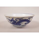 A Chinese blue and white porcelain dish decorated with dragons chasing the flaming pearl, seal