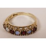 A silver gilt opal and red stone dress ring, size 'R'