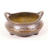 A Chinese bronze censer with twisted loop handles, impressed seal mark to base, 4" diameter