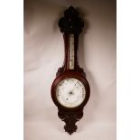 An Edwardian oak aneroid barometer, well carved in good original condition, ready for wall