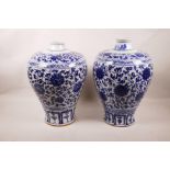 A matched pair of Chinese blue and white pottery meiping vases with scrolling lotus flower