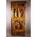 A Chinese carved and pierced giltwood panel depicting four figures in a landscape, 15½" x 37½"