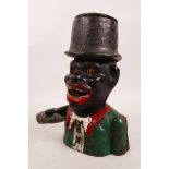 A painted cast iron 'Jolly Nigger' money box, 8" high