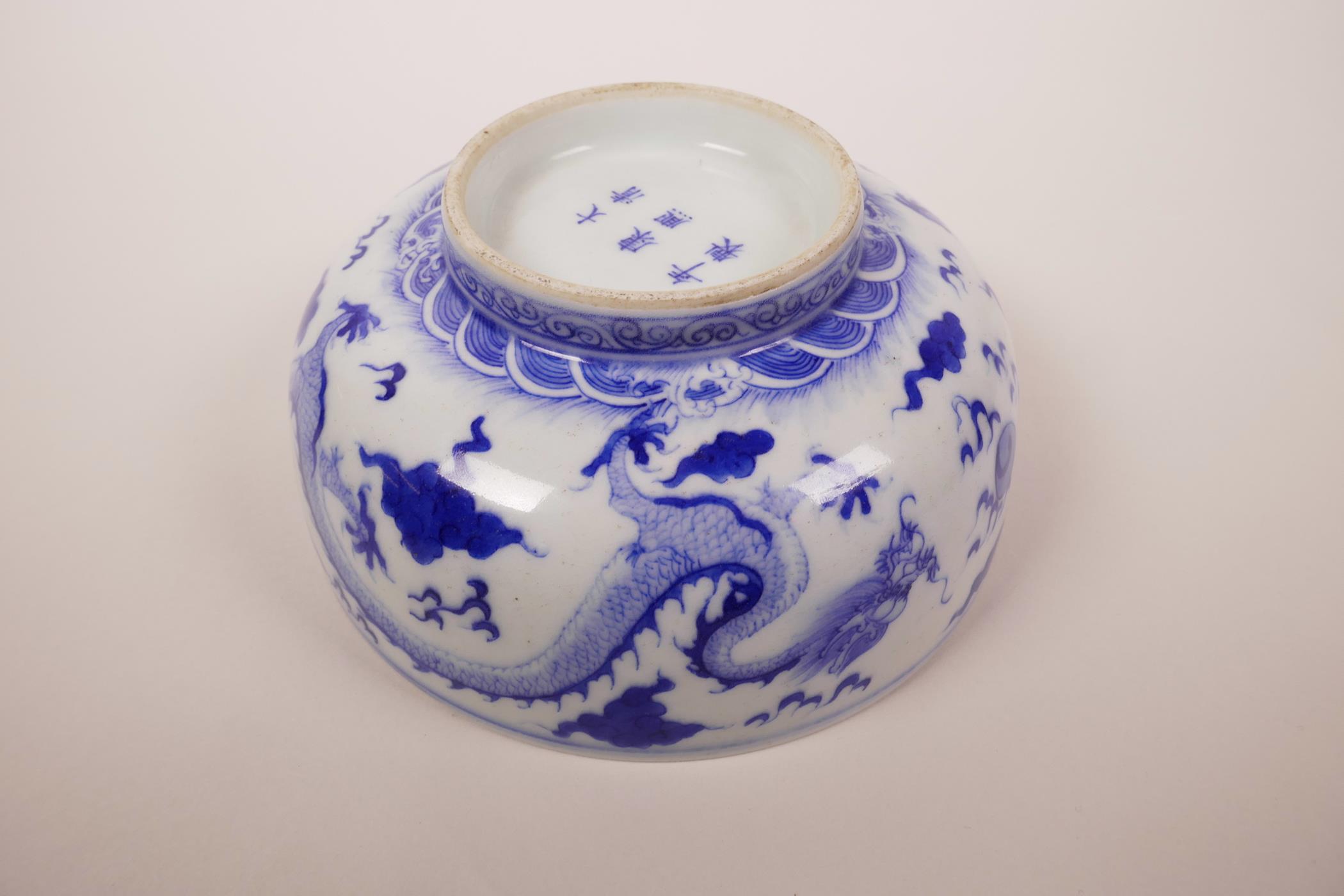 A Chinese blue and white porcelain bowl decorated with a dragon chasing the flaming pearl, 6 - Image 4 of 6