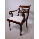 A C19th Continental figured mahogany elbow chair with carved dolphin decoration to back, 32½" high