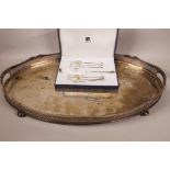 A large oval silver plated gallery tray on ball feet, 24" x 16", together with a boxed Silea set