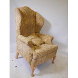 A Georgian style wing back armchair