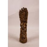 A Tibetan bone seal/incense holder with carved and gilt decoration of a wrathful spirit, 8" long
