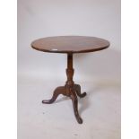 A C19th oak tilt top table on tripod supports, 28" high x 29" diameter