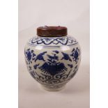 A Chinese blue and white ginger jar and wood cover, with phoenix decoration, rabbit mark to base, 8"