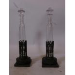 A pair of C19th French glass decanters with stoppers, in pierced bronze holders with Gothic