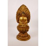 A Chinese gilt bronze of Buddha seated on a lotus throne, mark to base, 15" high