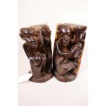 A pair of lignum vitae African bookends with carved figural decoration, 8" high