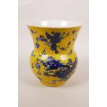 A Chinese yellow glazed porcelain vase with blue and white decoration of a dragon and cranes in