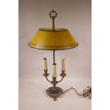 A brassed metal three branch table lamp with a painted adjustable toleware shade, 26" high