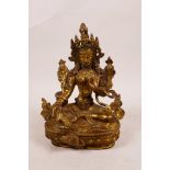 A Tibetan gilt bronze of Shiva seated on a lotus throne, 6" high