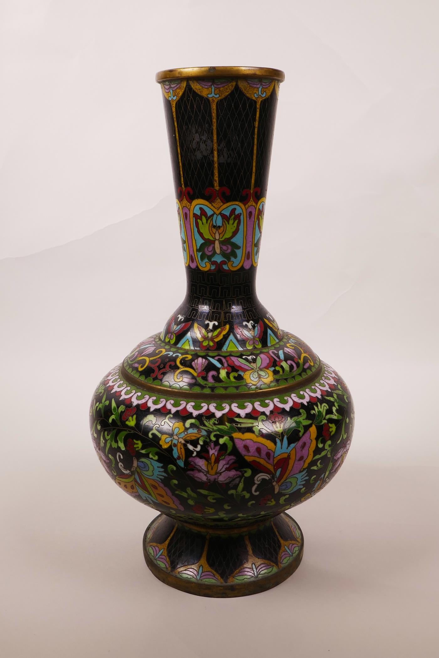 A Chinese black ground cloisonné vase, decorated with butterflies and lotus flowers, A/F repair, 12"