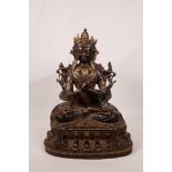 A Sino-Tibetan bronze and iron of Buddha seated on a lotus throne with inset semi-precious stones,