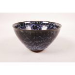 A Chinese Jian kiln rice bowl with a water style glaze, impressed character mark to base, 5"