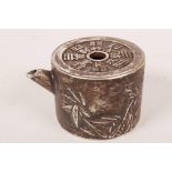 A small Chinese white metal pourer in the form of a teapot decorated with character marks and