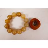 A horn bead together with a beaded horn bracelet, bracelet 4" diameter