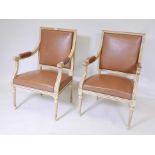 A pair of Italian painted open armchairs, with studded leatherette covers
