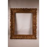 An early C20th carved limed wood picture frame, aperture size 20" x 16½"