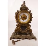 A Victorian brass mantel clock with some gilt decoration, and winding key, 13" high x 8" wide