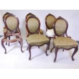 A set of six Victorian walnut dining chairs, with carved spoon backs and serpentine fronts, raised