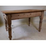 A Victorian stripped pine scullery table, with single end drawer, raised on turned supports, 35" x