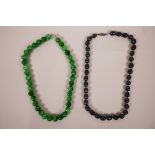 A string of apple green hardstone beads, together with a string of Tahitian black pearls, longest