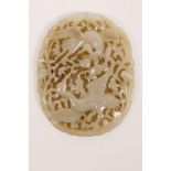 A Chinese carved and pierced celadon jade pendant decorated with storks in flight, 2½" x 3"