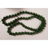 A long string of spinach green jade beads, 32" long