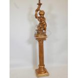 A plaster cherub lamp on a gilt fluted column, lamp 30" high, column 36" high