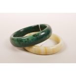 A Chinese marbled green hardstone bangle, together with an agate bangle, 3" diameter