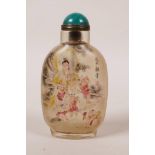 A Chinese reverse painted glass snuff bottle decorated with Quan Yin and children, character