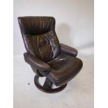 An Ekornes Stressless style brown leather recliner chair, 39" high