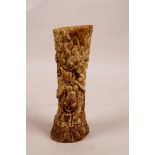 A Tibetan carved bone seal/stamp decorated with a semi-clad deity, 6" long