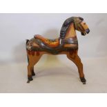 A carved and painted wood figure of a horse, 35" high