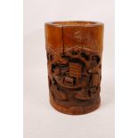 A Chinese bamboo brush pot with carved decoration of figures and sailing boats, 8" high