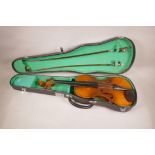 A replica Stradivarius violin with two bows and fitted case, 23" long