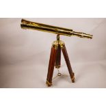 A brass telescope on an adjustable brass and wood tripod, telescope 16½" long