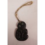 A Maori carved greenstone Hei-Tiki pendant with abalone set eyes, 4" x 2½"