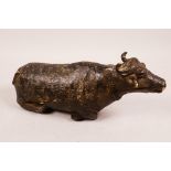 An Indian antique mixed metal figure of a cow, 8" long
