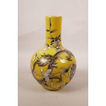 A Chinese polychrome porcelain vase, decorated with a black and gilt dragon amongst flowers on a