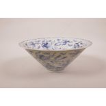 A Chinese blue and white porcelain conical bowl with a lobed rim, decorated with mythical